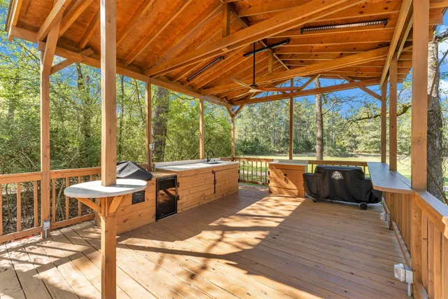 a view of a patio with chairs and wooden floor