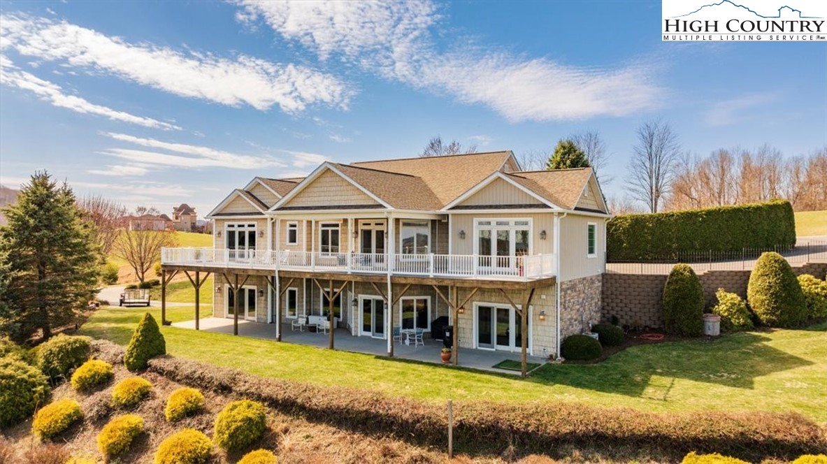 368 Fox Run Lane Sparta, NC 28675 - Photo 1 of 50 a view of a white house with a large pool and a yard