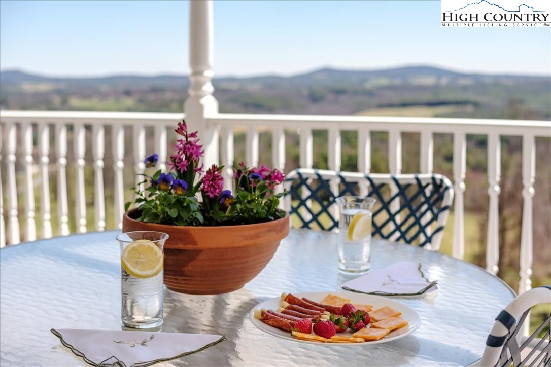 368 Fox Run Lane Sparta, NC 28675 - Photo 22 of 50 a vase of flowers sitting on a table with kitchen view