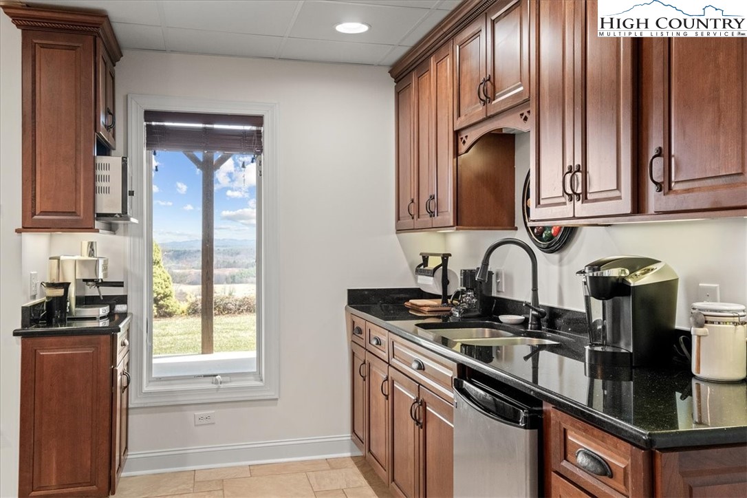 368 Fox Run Lane Sparta, NC 28675 - Photo 29 of 50 a kitchen with granite countertop stainless steel appliances a sink stove and cabinets