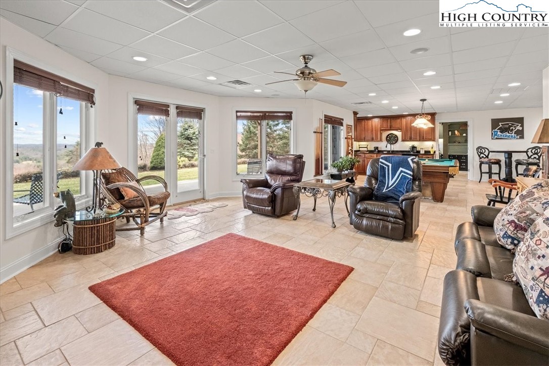 368 Fox Run Lane Sparta, NC 28675 - Photo 34 of 50 a living room with furniture a rug and a large window