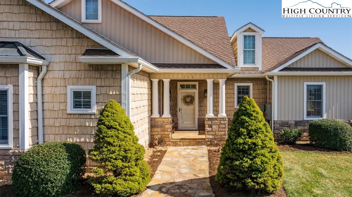 368 Fox Run Lane Sparta, NC 28675 - Photo 49 of 50 a front view of a house with a yard and potted plants