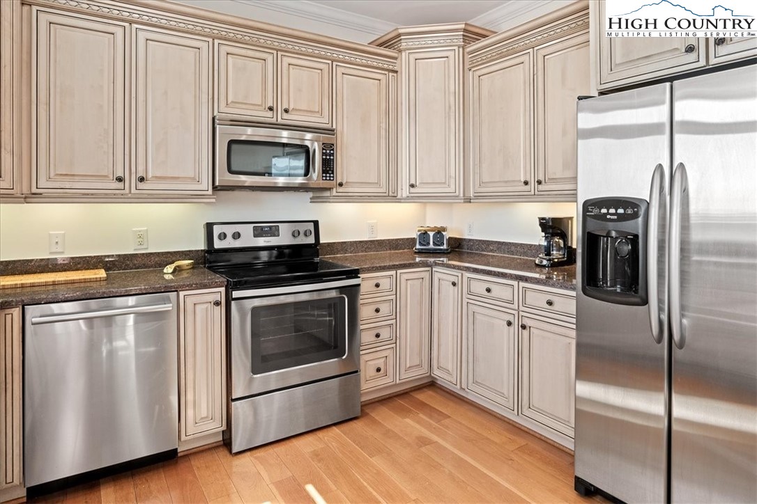 368 Fox Run Lane Sparta, NC 28675 - Photo 6 of 50 a kitchen with white cabinets and stainless steel appliances