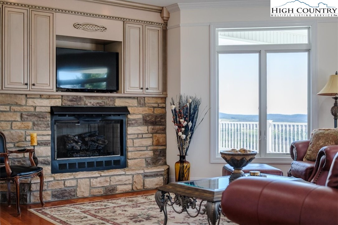 368 Fox Run Lane Sparta, NC 28675 - Photo 9 of 50 a living room with furniture a flat screen tv and a fireplace