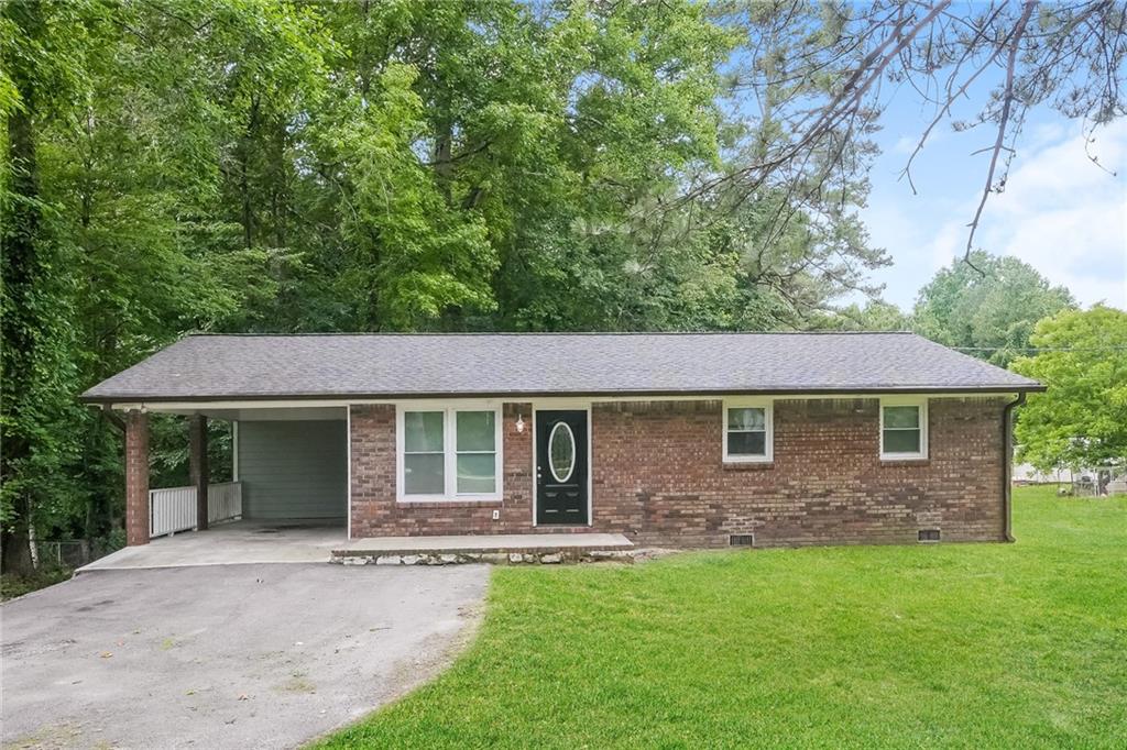 3371 Richardson Road Villa Rica, GA 30180 - Photo 1 of 1 a front view of a house with a garden