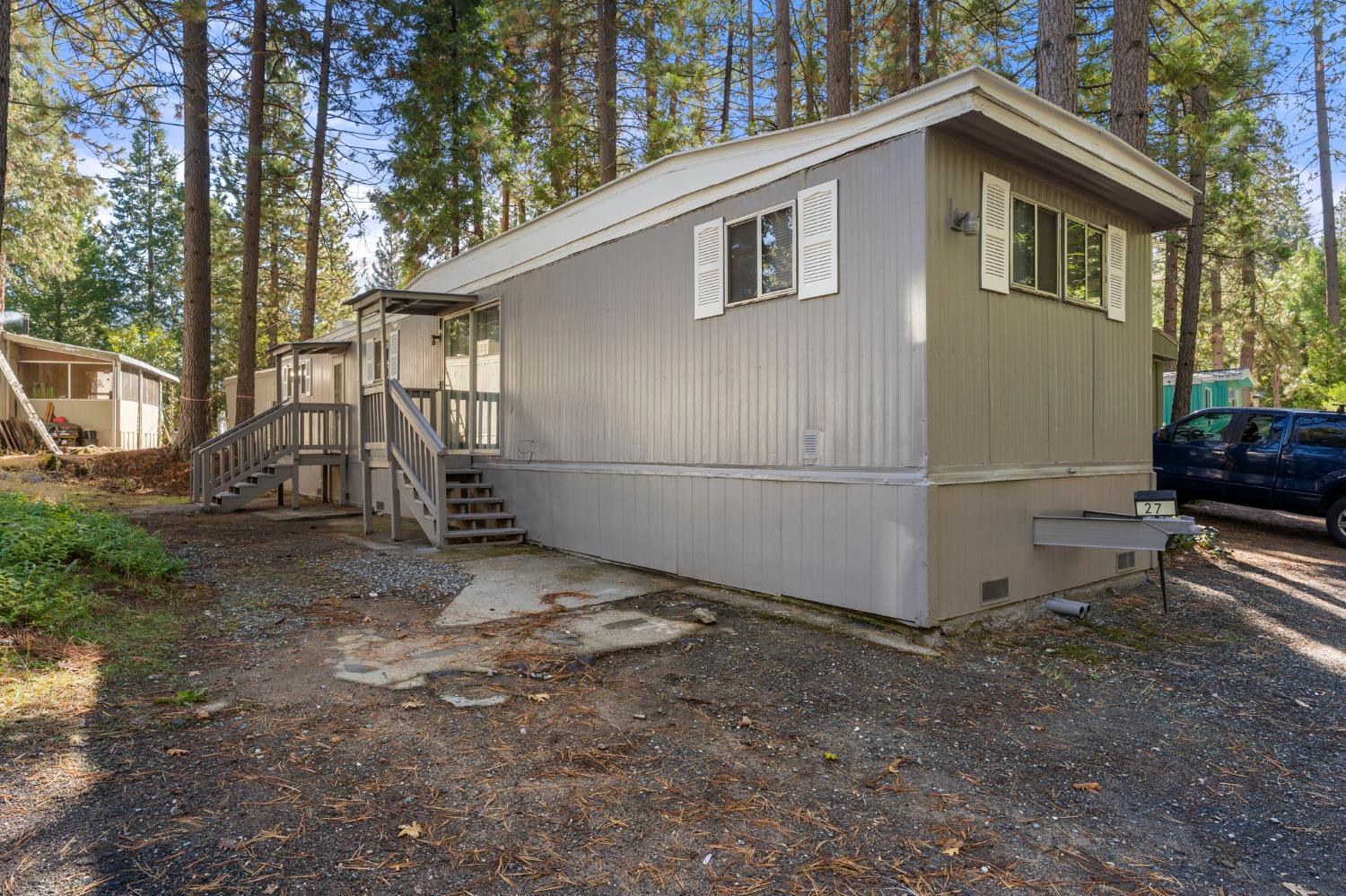 a backyard of a house with barbeque oven table and chairs