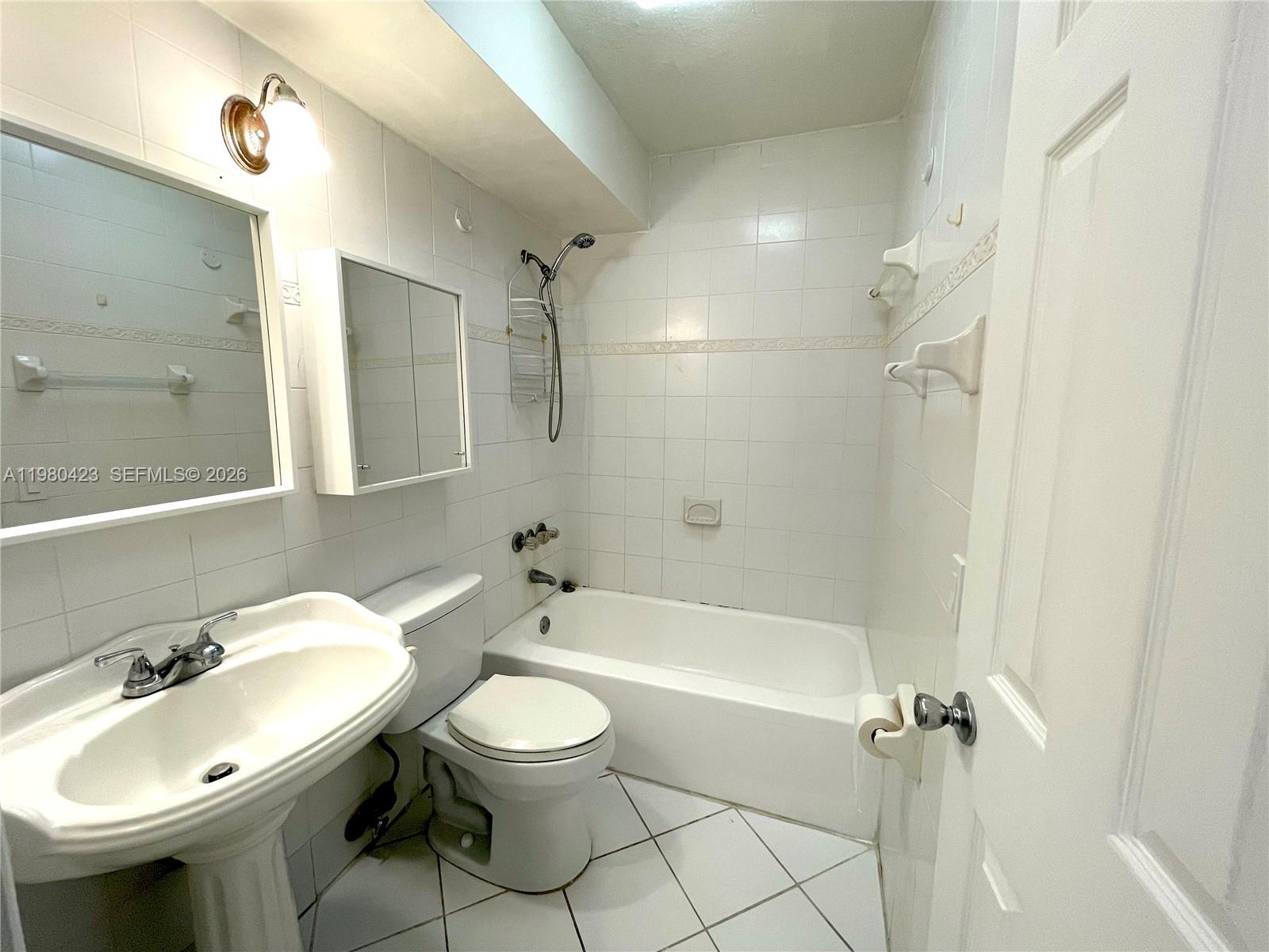 2138 Southwest 6th Street, Unit 201 Miami, FL 33135 - Photo 11 of 18 a bathroom with a sink a toilet and shower