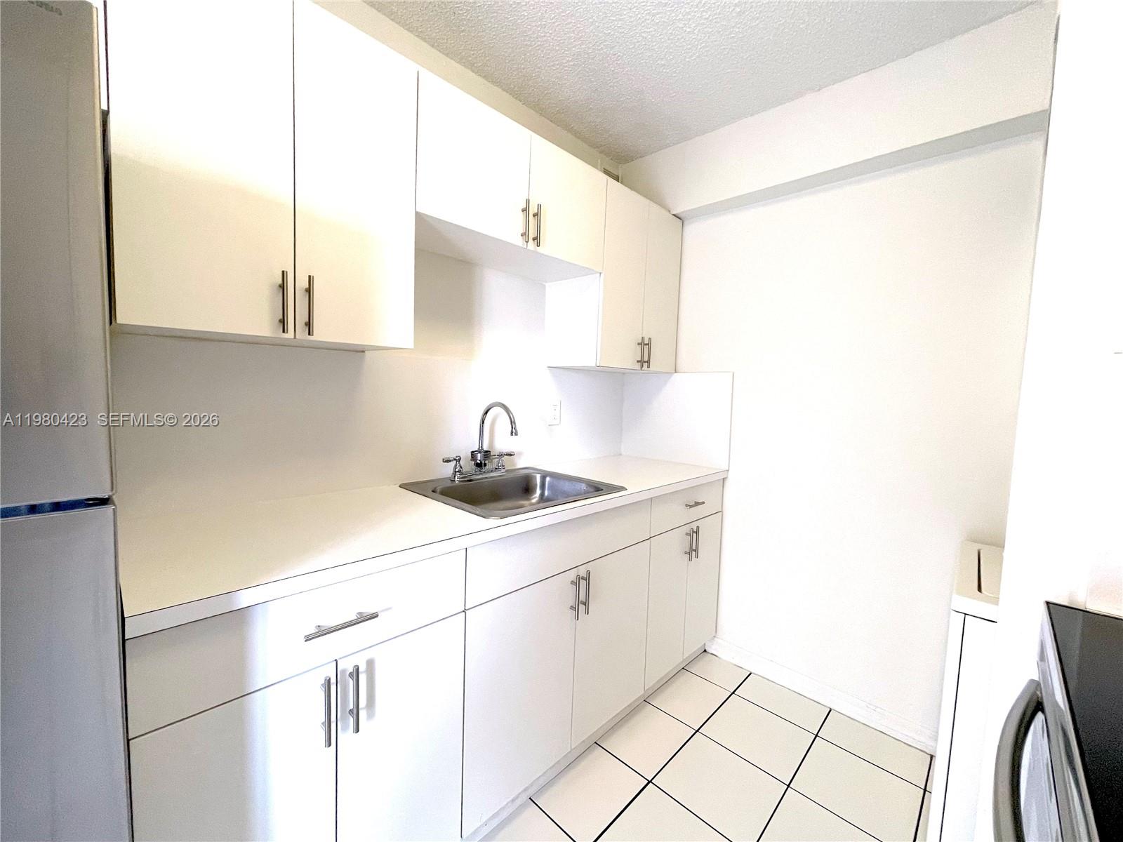 2138 Southwest 6th Street, Unit 201 Miami, FL 33135 - Photo 14 of 18 a kitchen with a sink cabinets and appliances