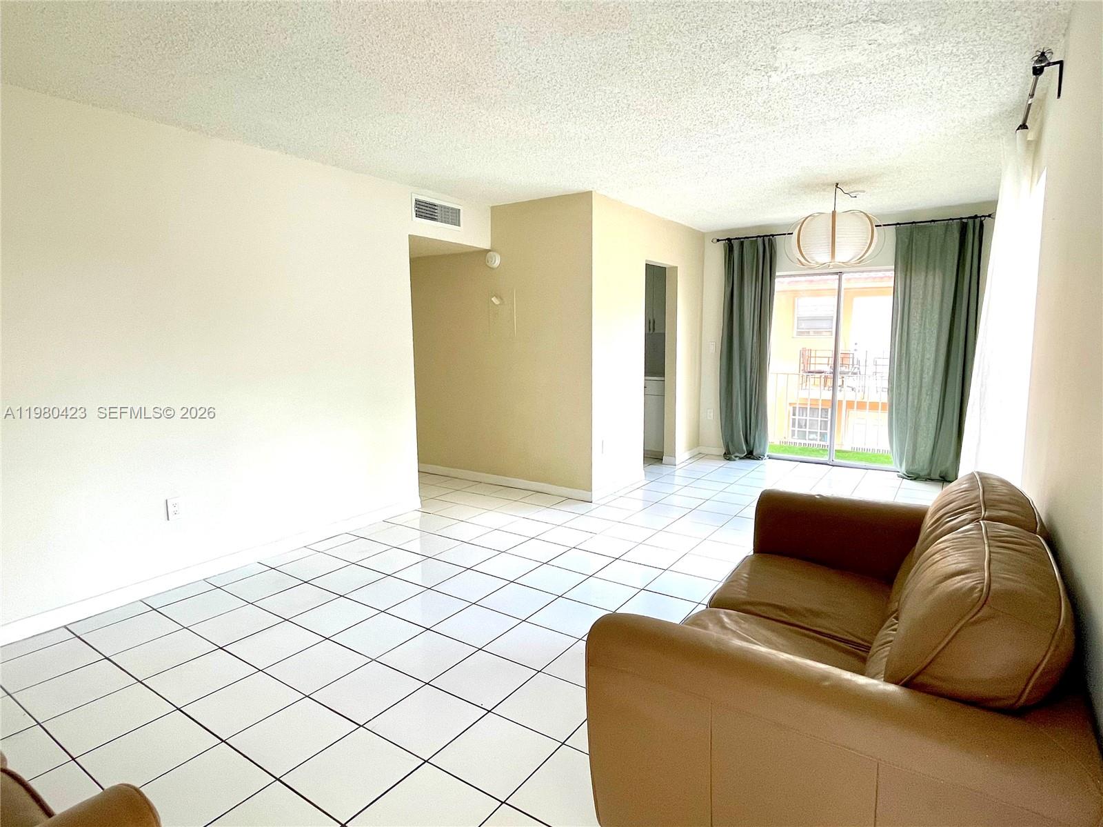 2138 Southwest 6th Street, Unit 201 Miami, FL 33135 - Photo 18 of 18 a bedroom with a bed and a couch with window