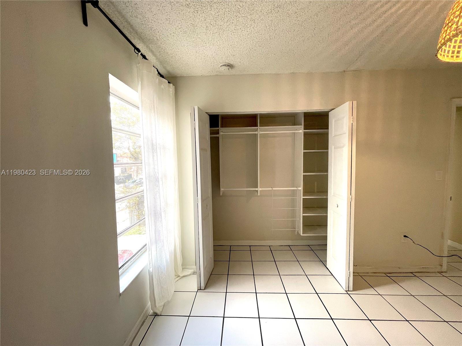 2138 Southwest 6th Street, Unit 201 Miami, FL 33135 - Photo 8 of 18 a view of an empty room and window