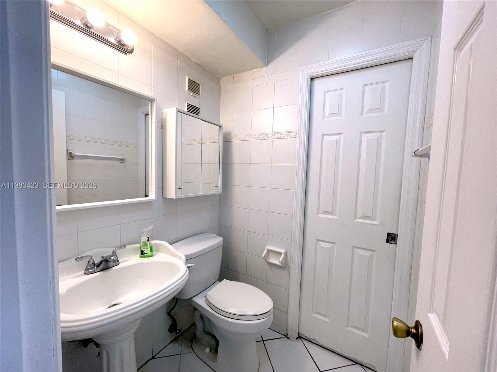 2138 Southwest 6th Street, Unit 201 Miami, FL 33135 - Photo 10 of 18 a bathroom with a sink toilet and shower