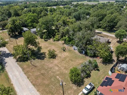 an aerial view of a house with a yard