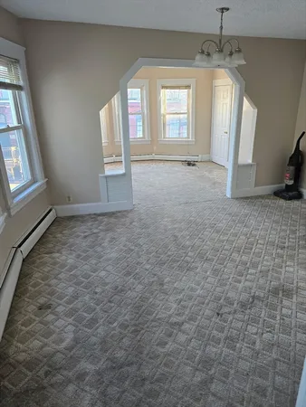 an empty room with windows and entrance