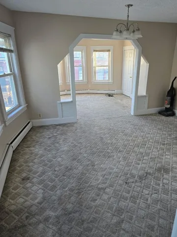 an empty room with windows and entrance