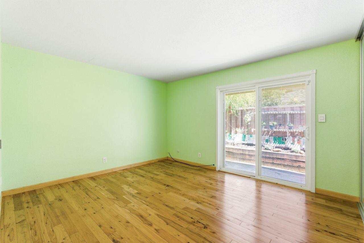 5561 Roundtree Common Fremont, CA 94538 - Photo 13 of 29 an empty room with wooden floor and windows