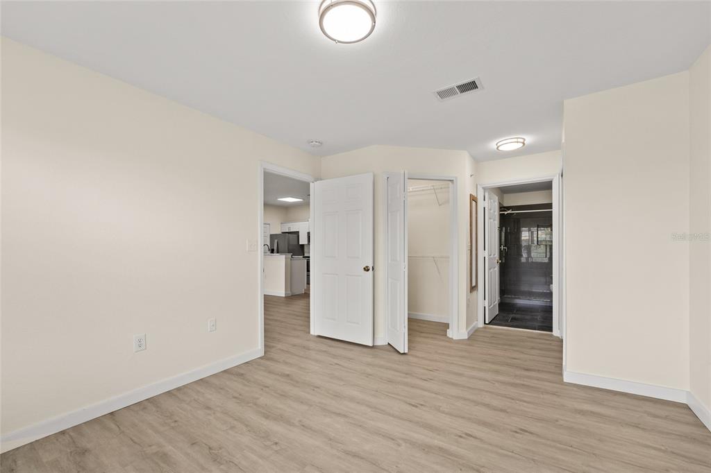 5447 Vineland Road, Unit 1308 Orlando, FL 32811 - Photo 16 of 31 a view of an empty room with wooden floor