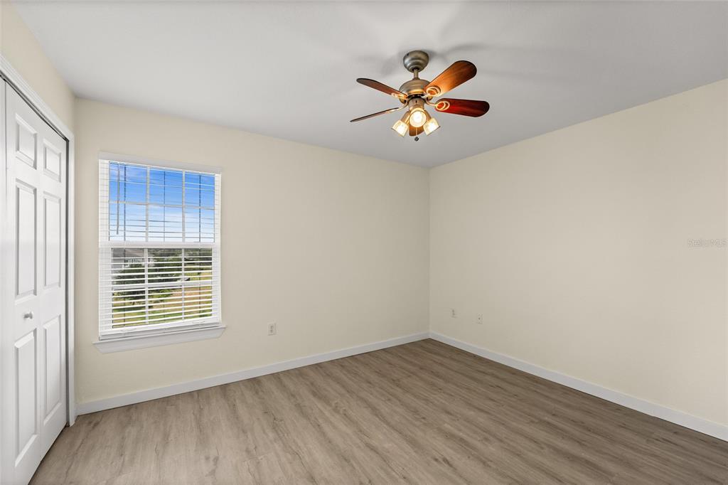 5447 Vineland Road, Unit 1308 Orlando, FL 32811 - Photo 20 of 31 a view of an empty room with wooden floor and a window