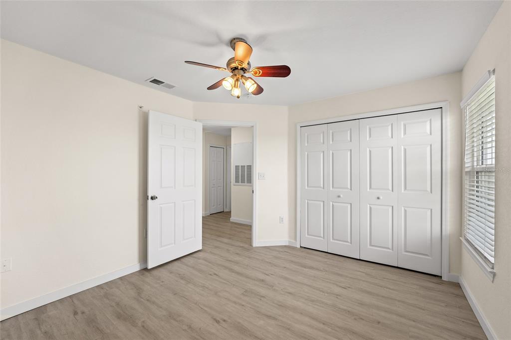 5447 Vineland Road, Unit 1308 Orlando, FL 32811 - Photo 21 of 31 wooden floor in an empty room with a window
