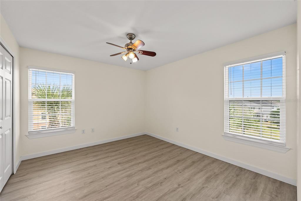 5447 Vineland Road, Unit 1308 Orlando, FL 32811 - Photo 22 of 31 a view of an empty room with a window and wooden floor
