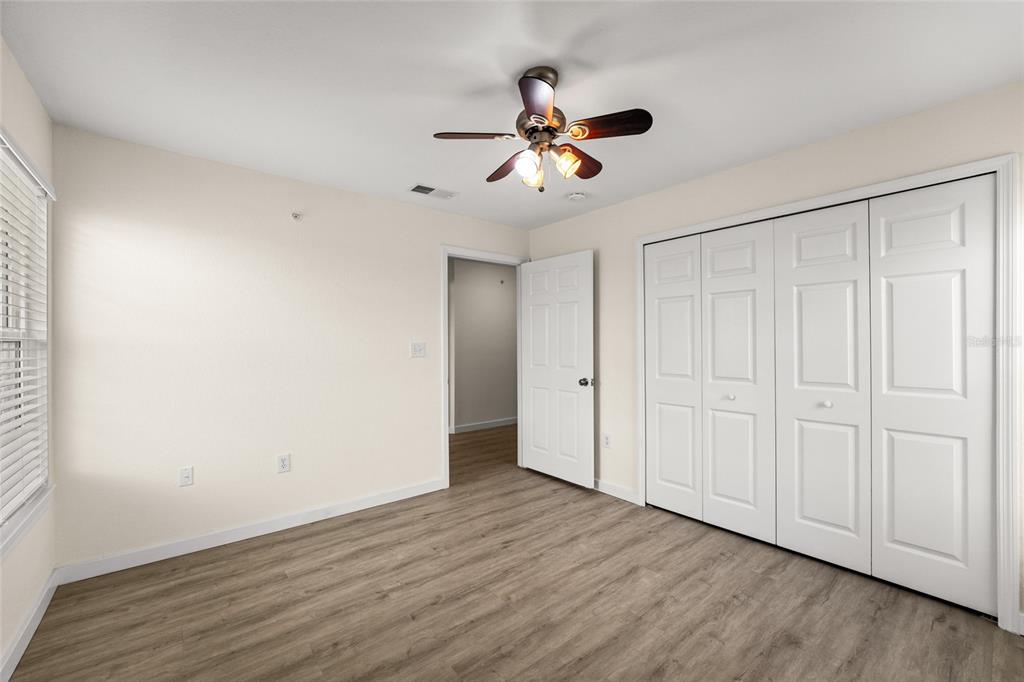 5447 Vineland Road, Unit 1308 Orlando, FL 32811 - Photo 23 of 31 a view of empty room with wooden floor and fan