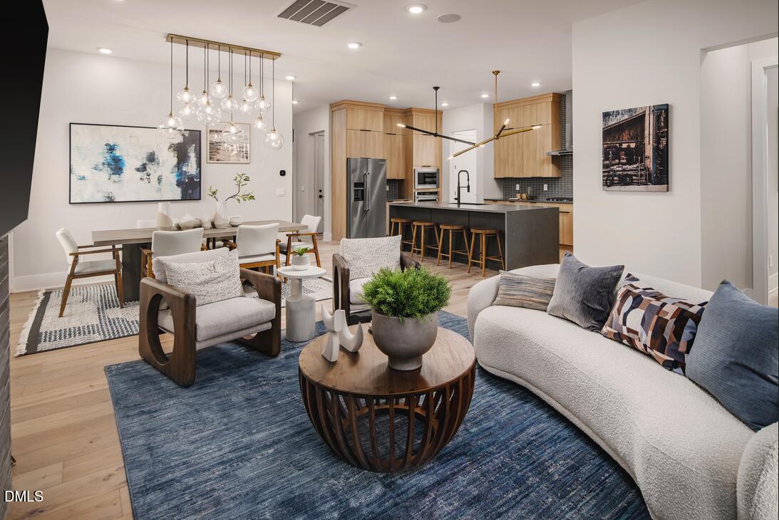 2424 Fleming Stone Lane, Unit 46 Raleigh, NC 27610 - Photo 6 of 27 a living room with furniture and a view of kitchen