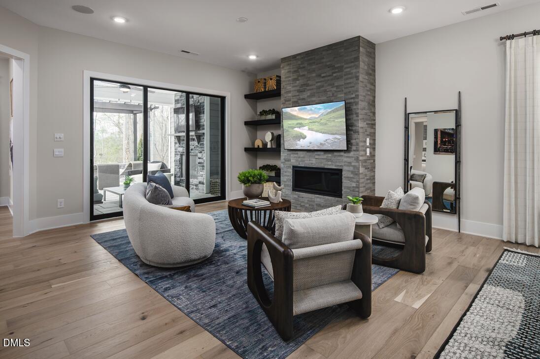 2424 Fleming Stone Lane, Unit 46 Raleigh, NC 27610 - Photo 7 of 27 a living room with fireplace furniture and a fireplace