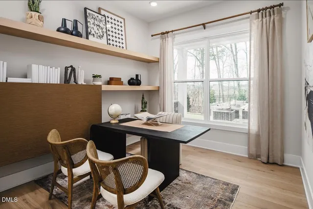 a kitchen with stainless steel appliances granite countertop a table chairs sink refrigerator and microwave