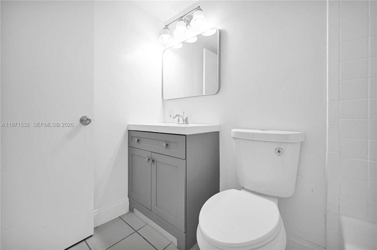 7550 Stirling Road, Unit V120 Davie, FL 33024 - Photo 22 of 27 a bathroom with a toilet a sink and mirror