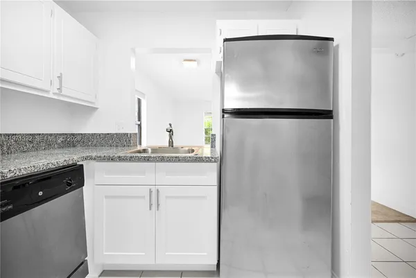 a kitchen with a refrigerator and cabinets