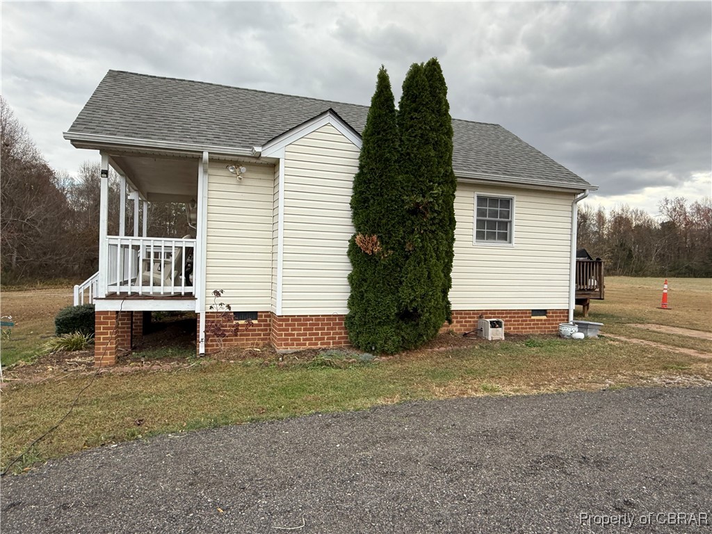 1342 Lewis Level Road Tappahannock, VA 22560 - Photo 7 of 8 View of property exterior with a lawn and covered porch