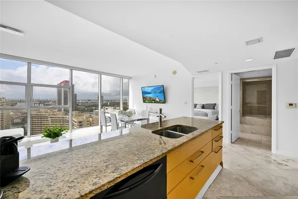 a kitchen with sink stove and cabinets