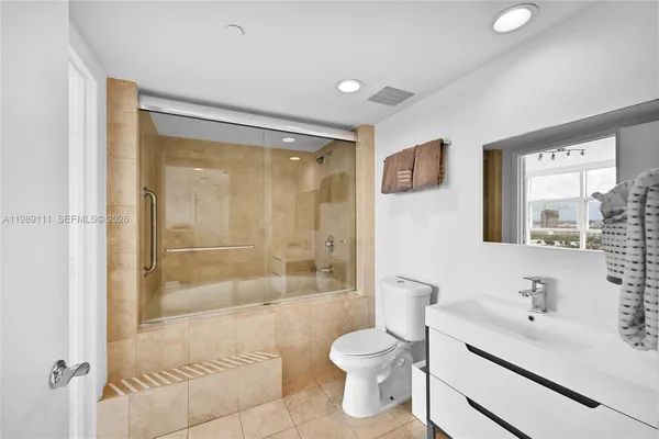 a bathroom with a sink toilet and shower