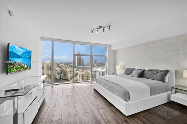 a view of a bedroom with furniture and windows