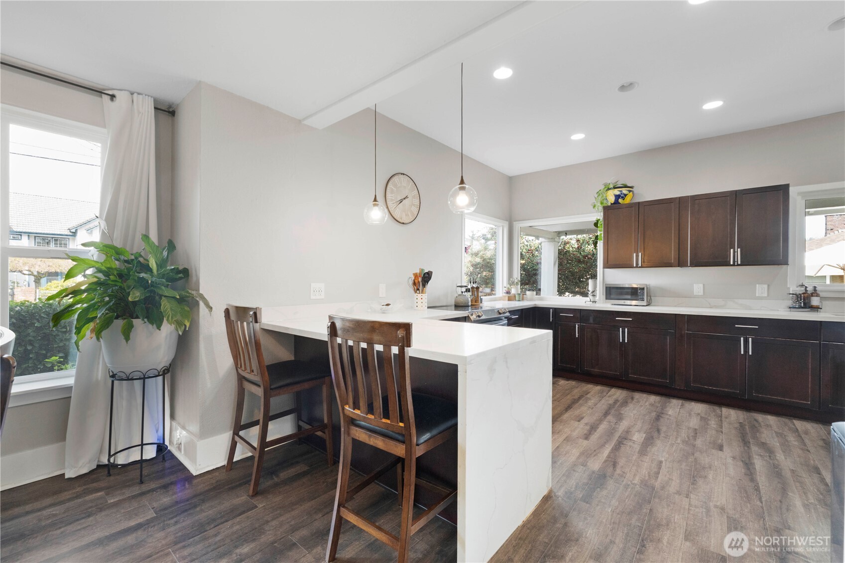 425 Valley Avenue East Sumner, WA 98390 - Photo 11 of 34 a kitchen with a table chairs sink and cabinets