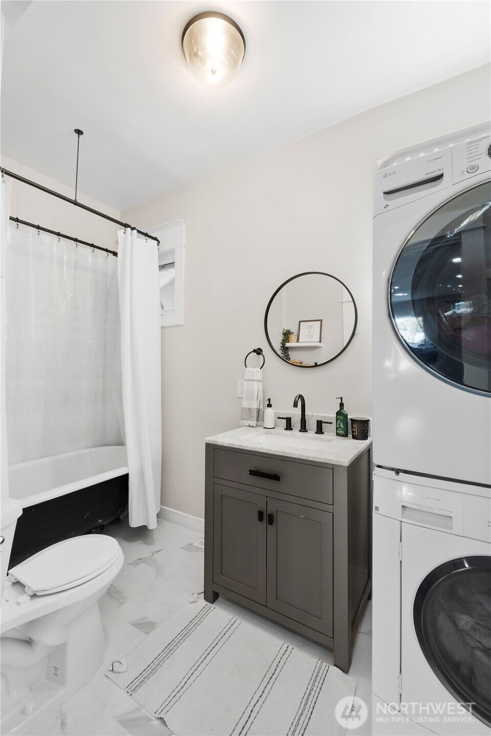 425 Valley Avenue East Sumner, WA 98390 - Photo 18 of 34 a bathroom with a toilet a sink and a mirror