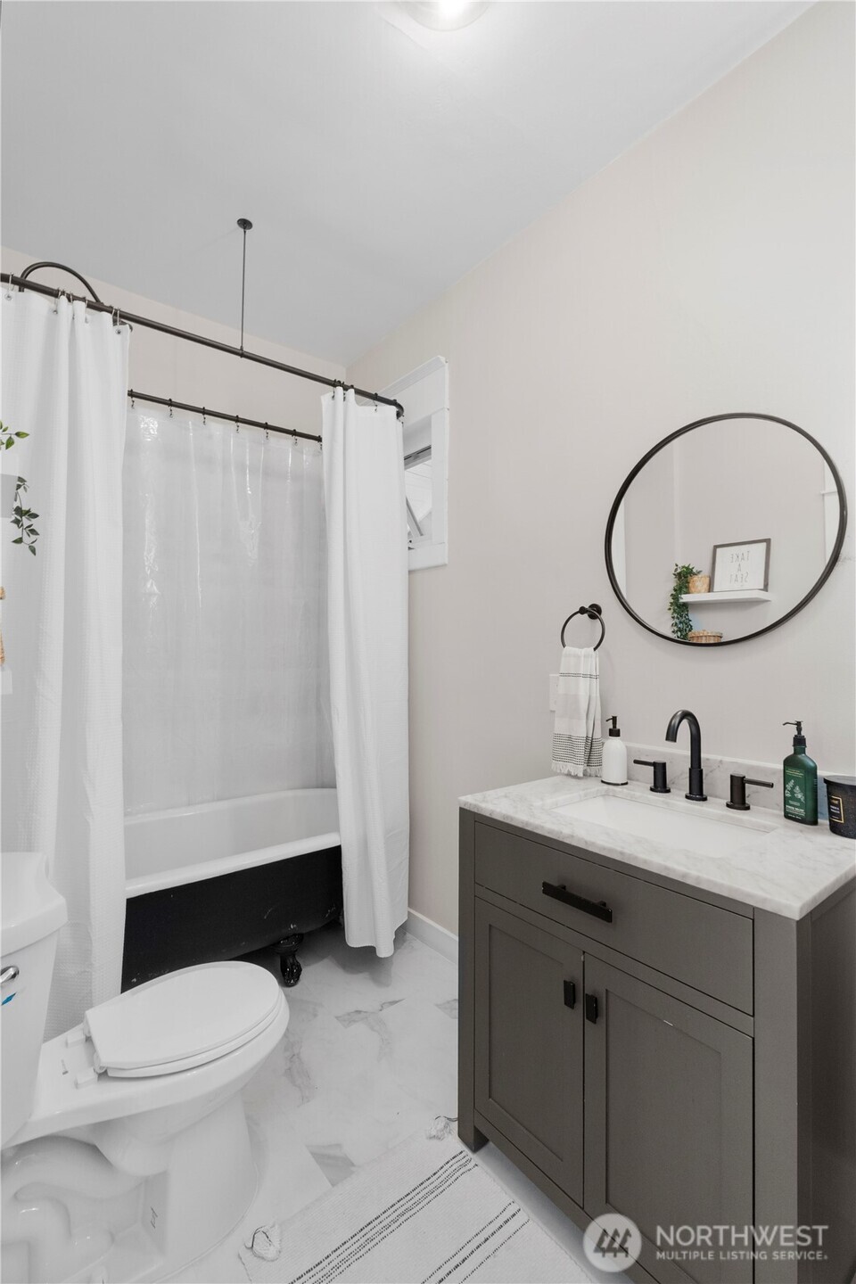425 Valley Avenue East Sumner, WA 98390 - Photo 19 of 34 a bathroom with a sink a toilet and a mirror
