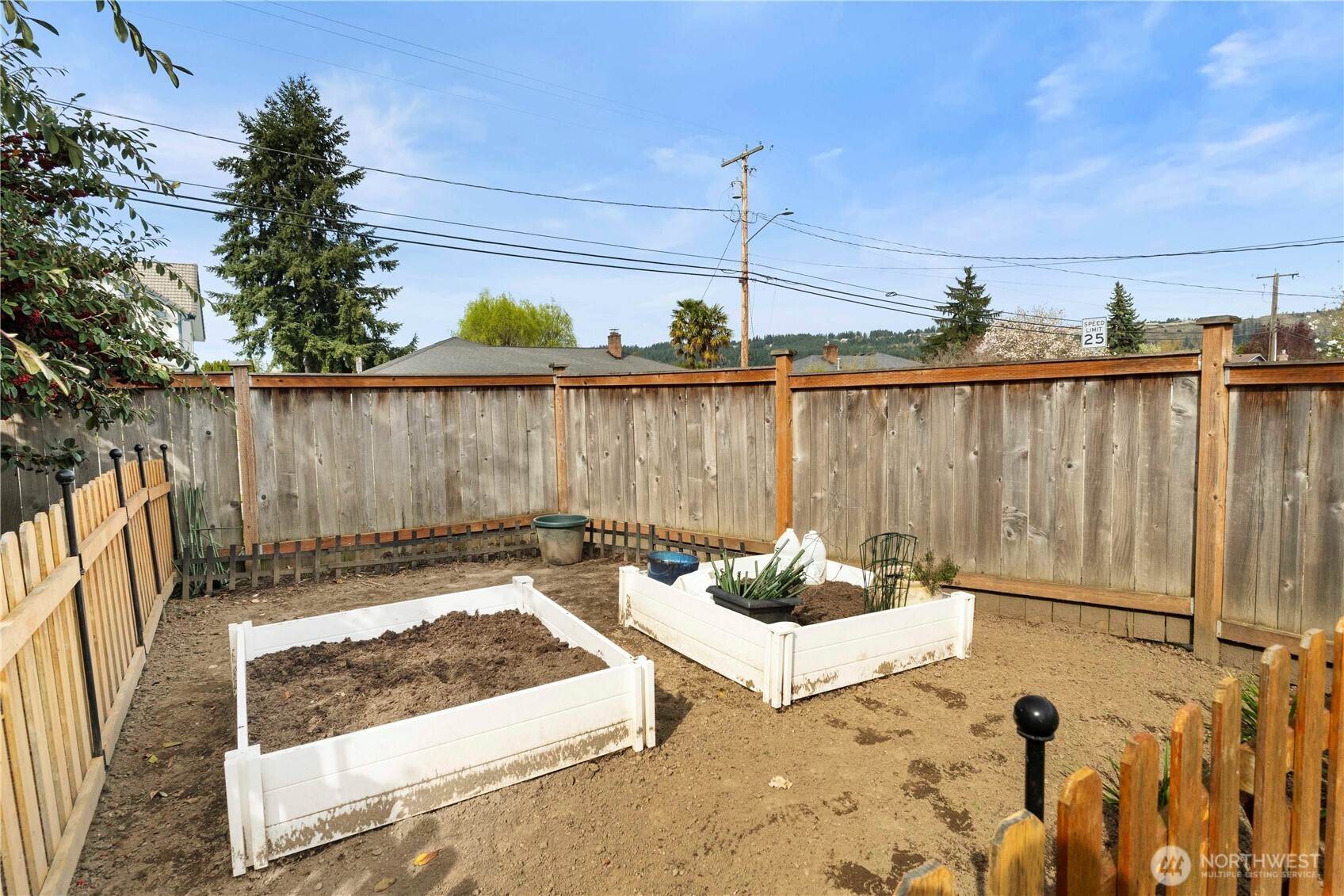 425 Valley Avenue East Sumner, WA 98390 - Photo 29 of 34 a view of a backyard with couches a fire pit and wooden fence