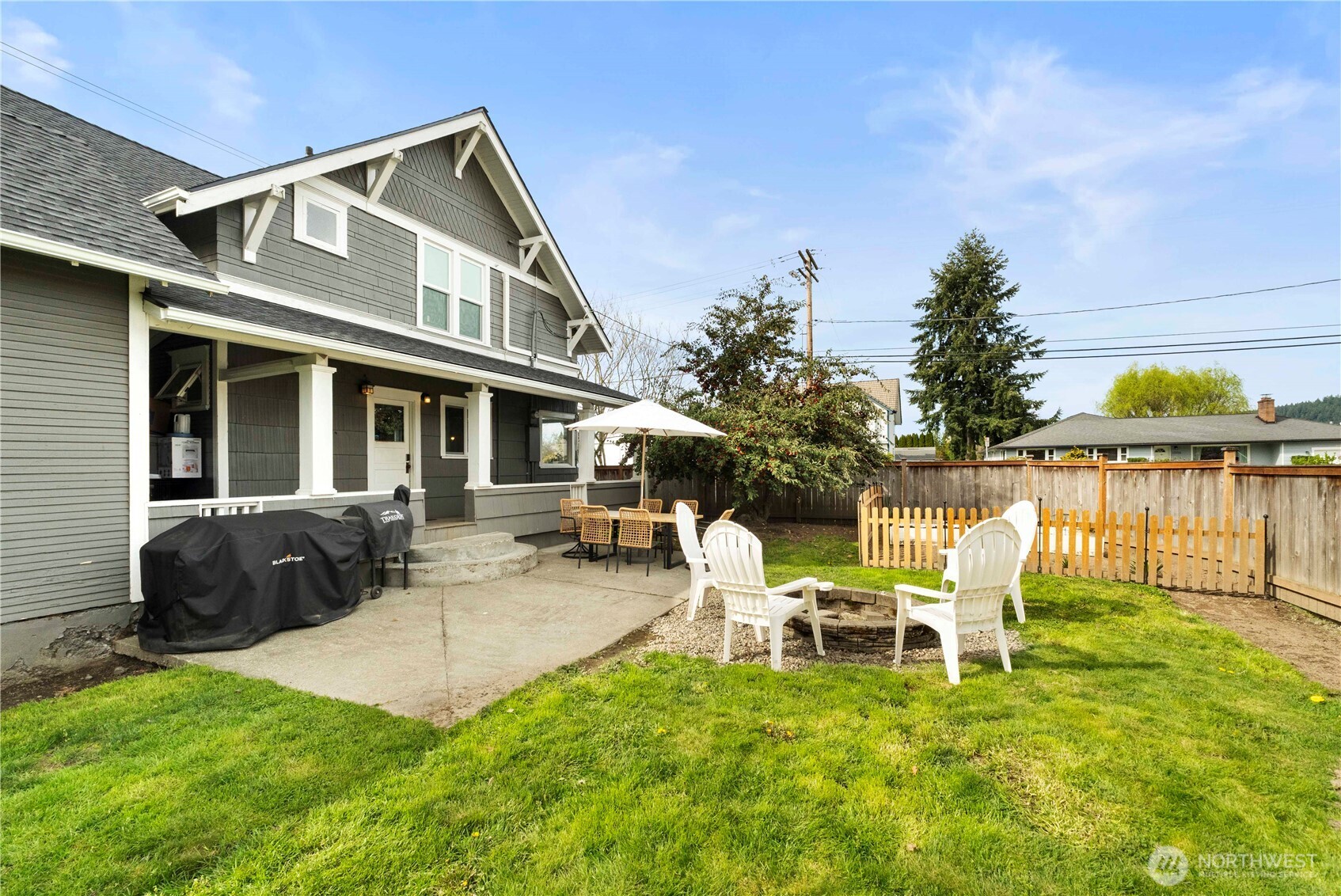 425 Valley Avenue East Sumner, WA 98390 - Photo 30 of 34 a front view of a house with patio and a garden