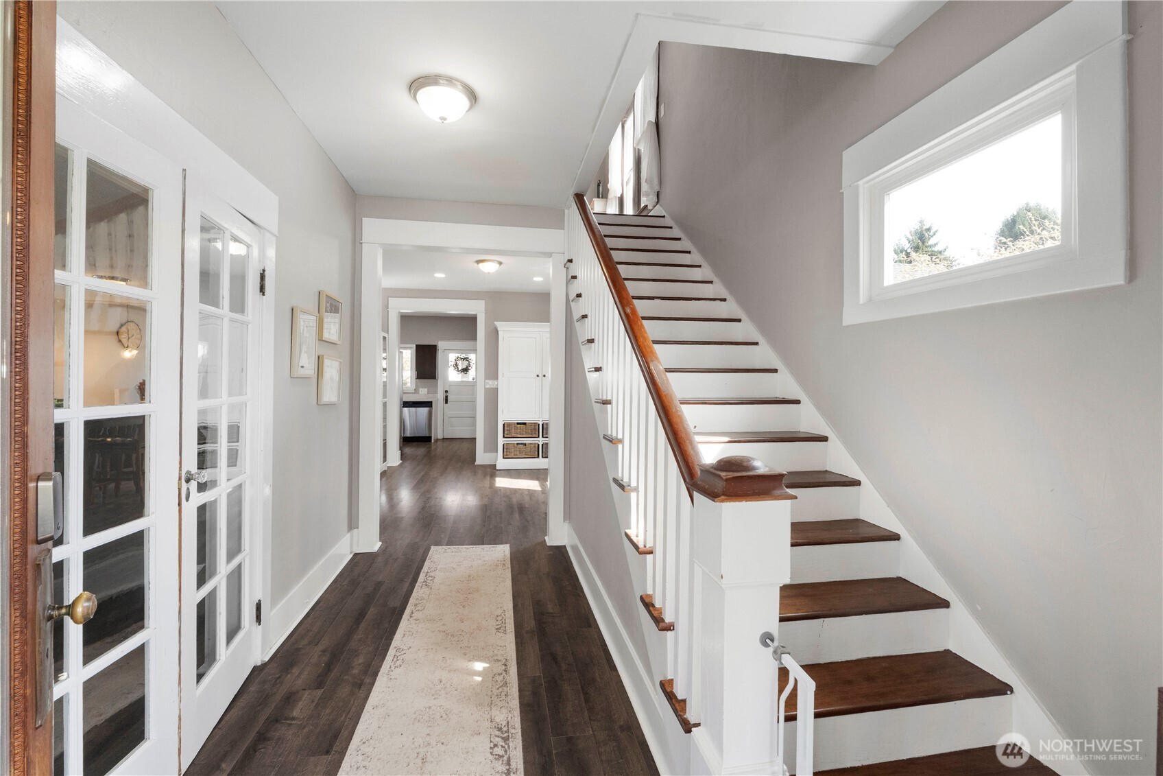 425 Valley Avenue East Sumner, WA 98390 - Photo 5 of 34 a view of a hallway with wooden floor and white walls