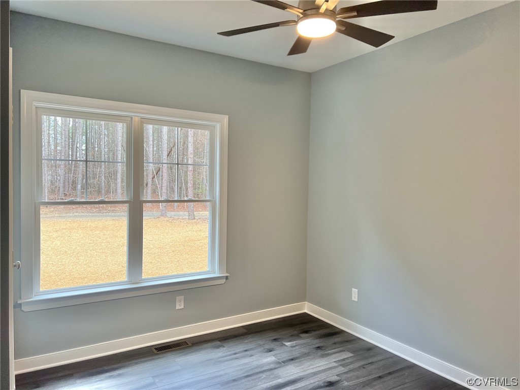 1072 Eastham Road Bumpass, VA 23024 - Photo 16 of 26 an empty room with wooden floor and windows