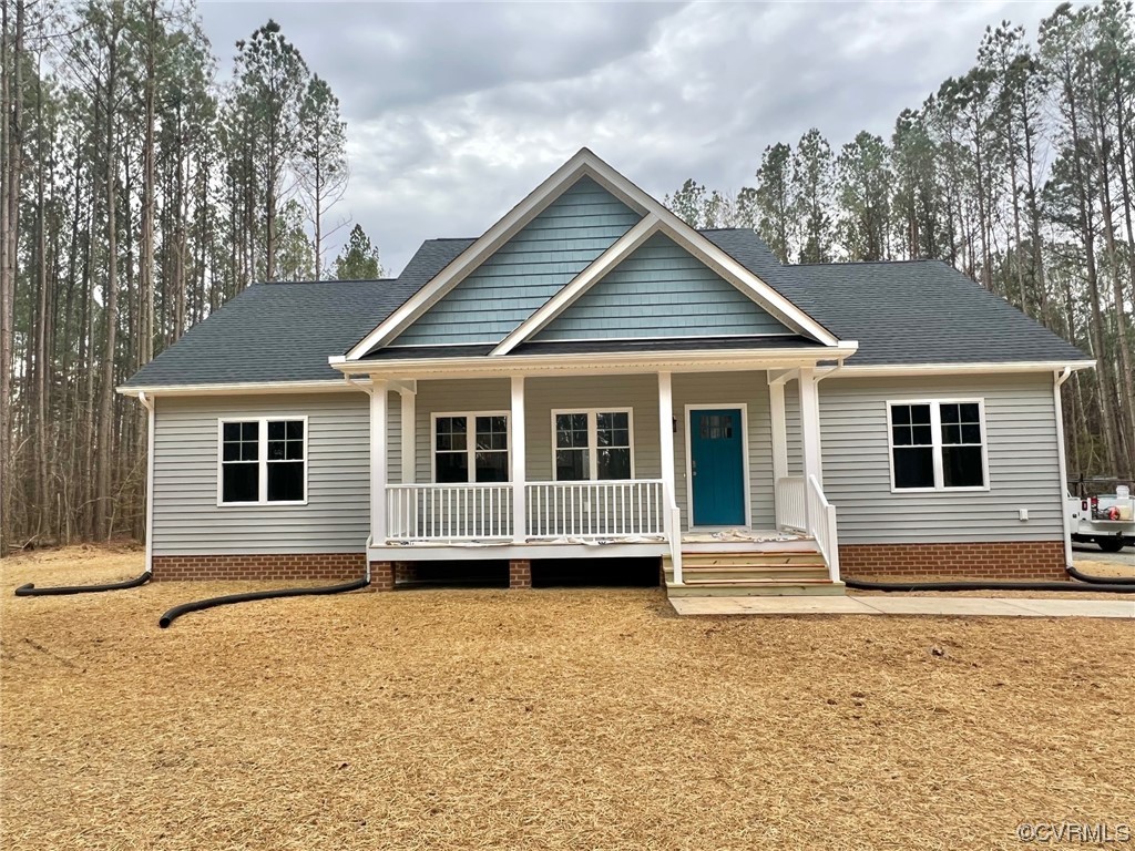 1072 Eastham Road Bumpass, VA 23024 - Photo 4 of 26 a front view of a house with a yard