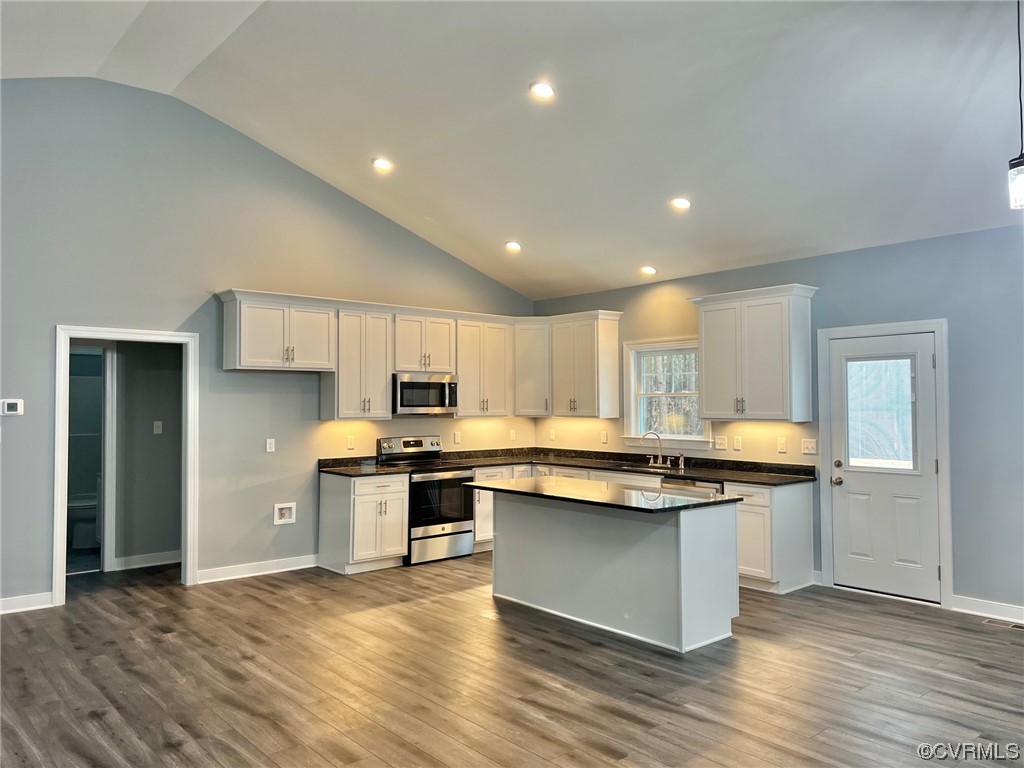 1072 Eastham Road Bumpass, VA 23024 - Photo 7 of 26 a kitchen with stainless steel appliances granite countertop a sink cabinets and wooden floor