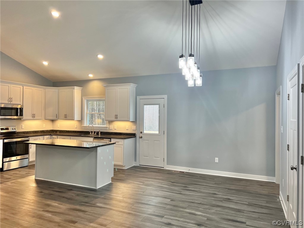 1072 Eastham Road Bumpass, VA 23024 - Photo 8 of 26 a kitchen with kitchen island granite countertop a sink stainless steel appliances and cabinets