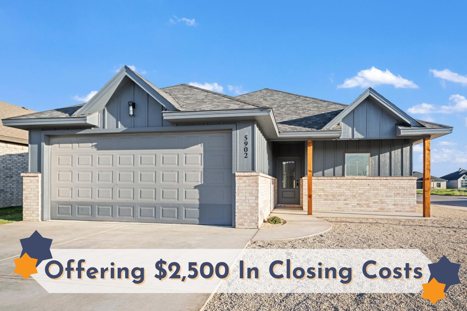 a front view of a house with a garden and yard