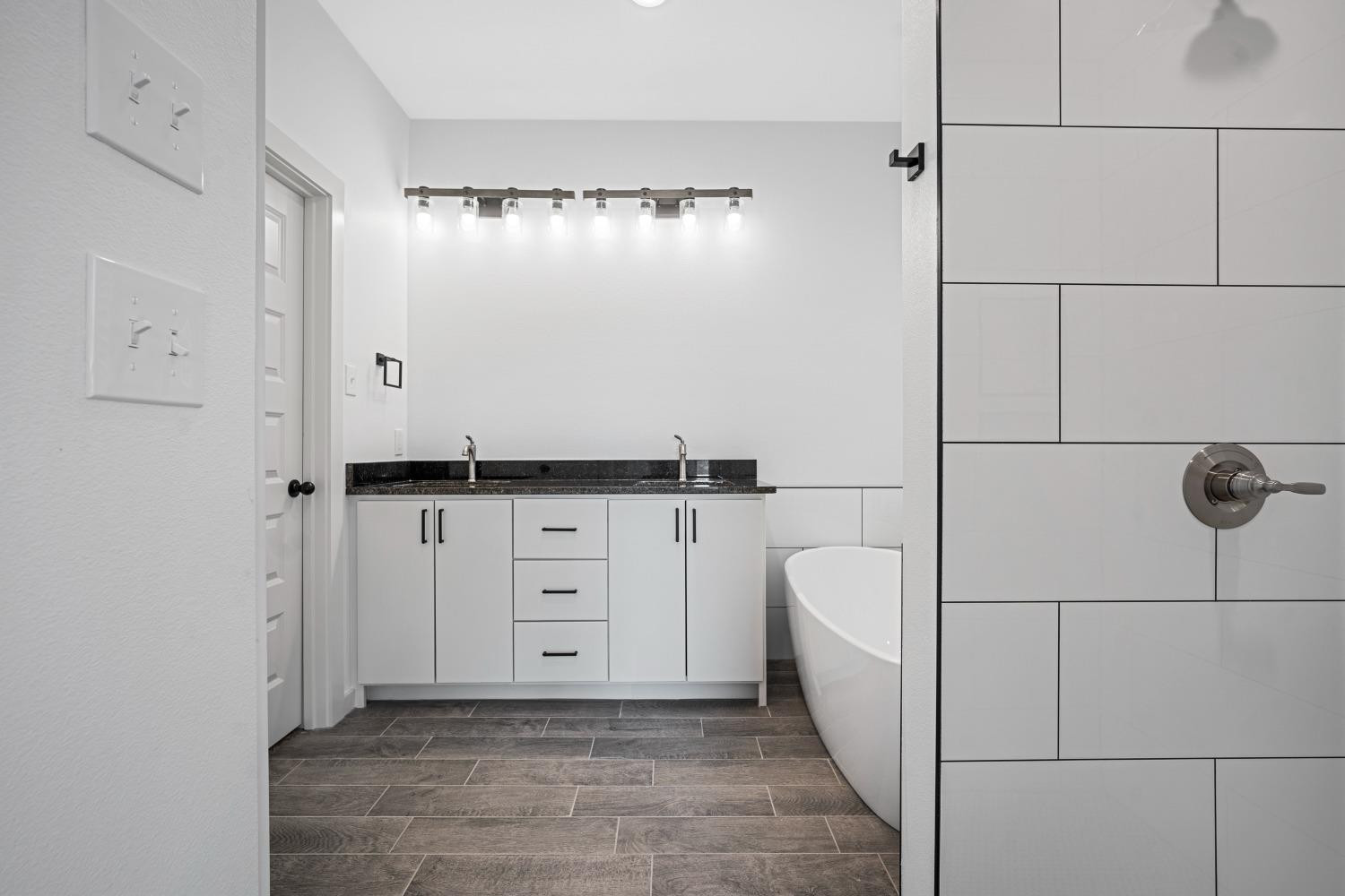 5902 Grinnell Street Lubbock, TX 79416 - Photo 15 of 26 a bathroom with a bathtub and shower