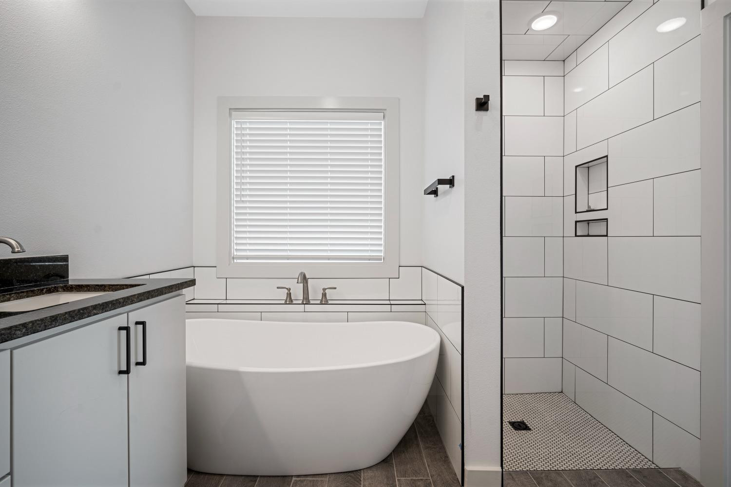 5902 Grinnell Street Lubbock, TX 79416 - Photo 17 of 26 a bathroom with a sink and a bathtub