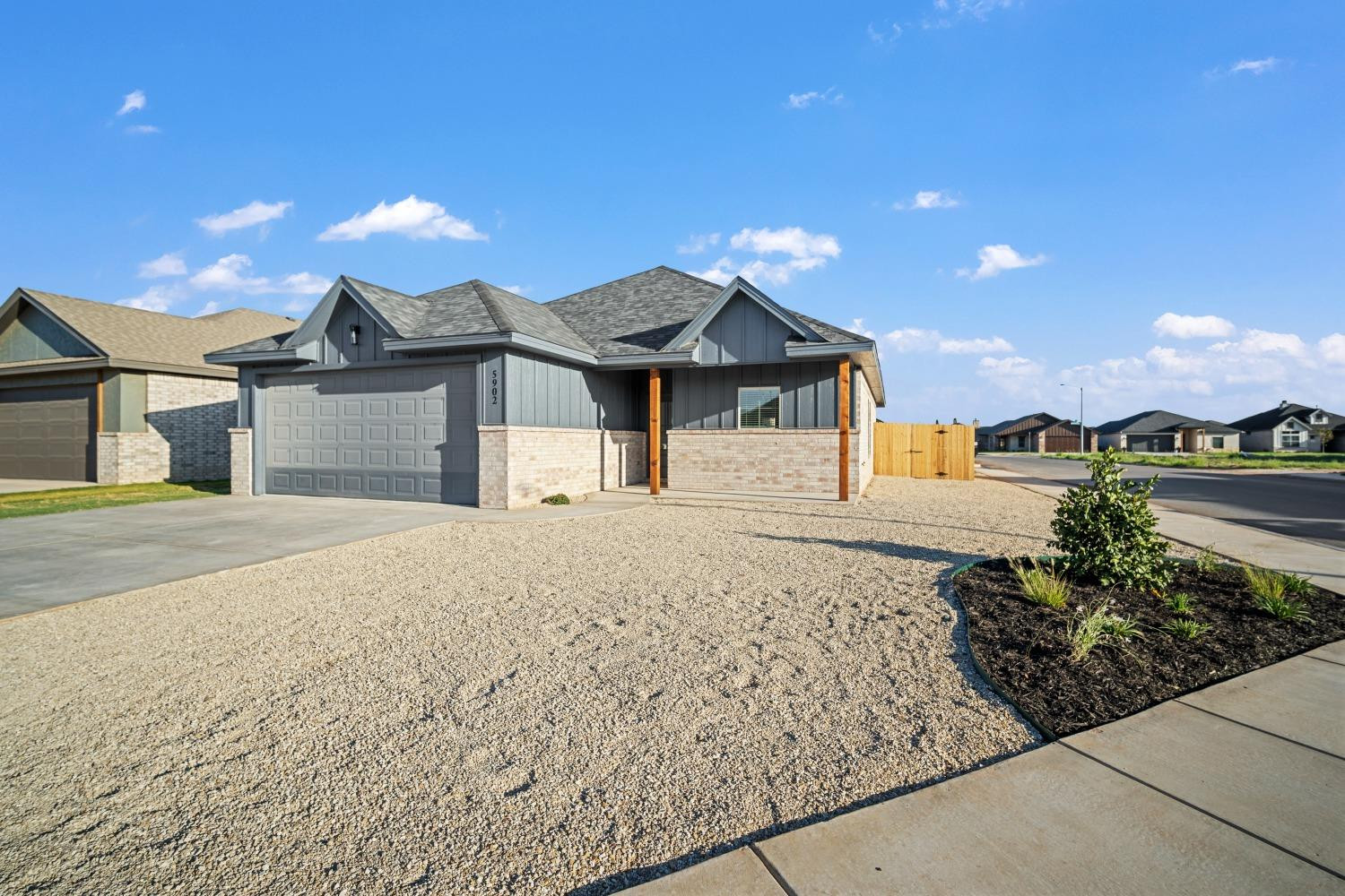 5902 Grinnell Street Lubbock, TX 79416 - Photo 2 of 26 a front view of a house with a garden