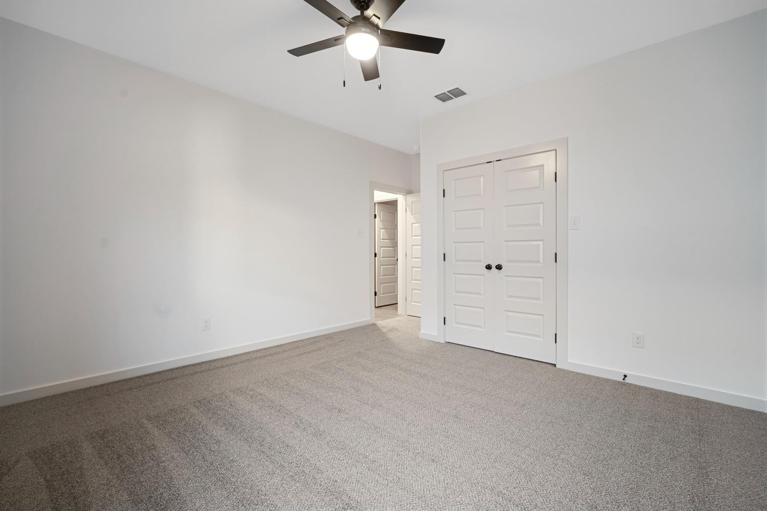 5902 Grinnell Street Lubbock, TX 79416 - Photo 24 of 26 an empty room with closet and windows