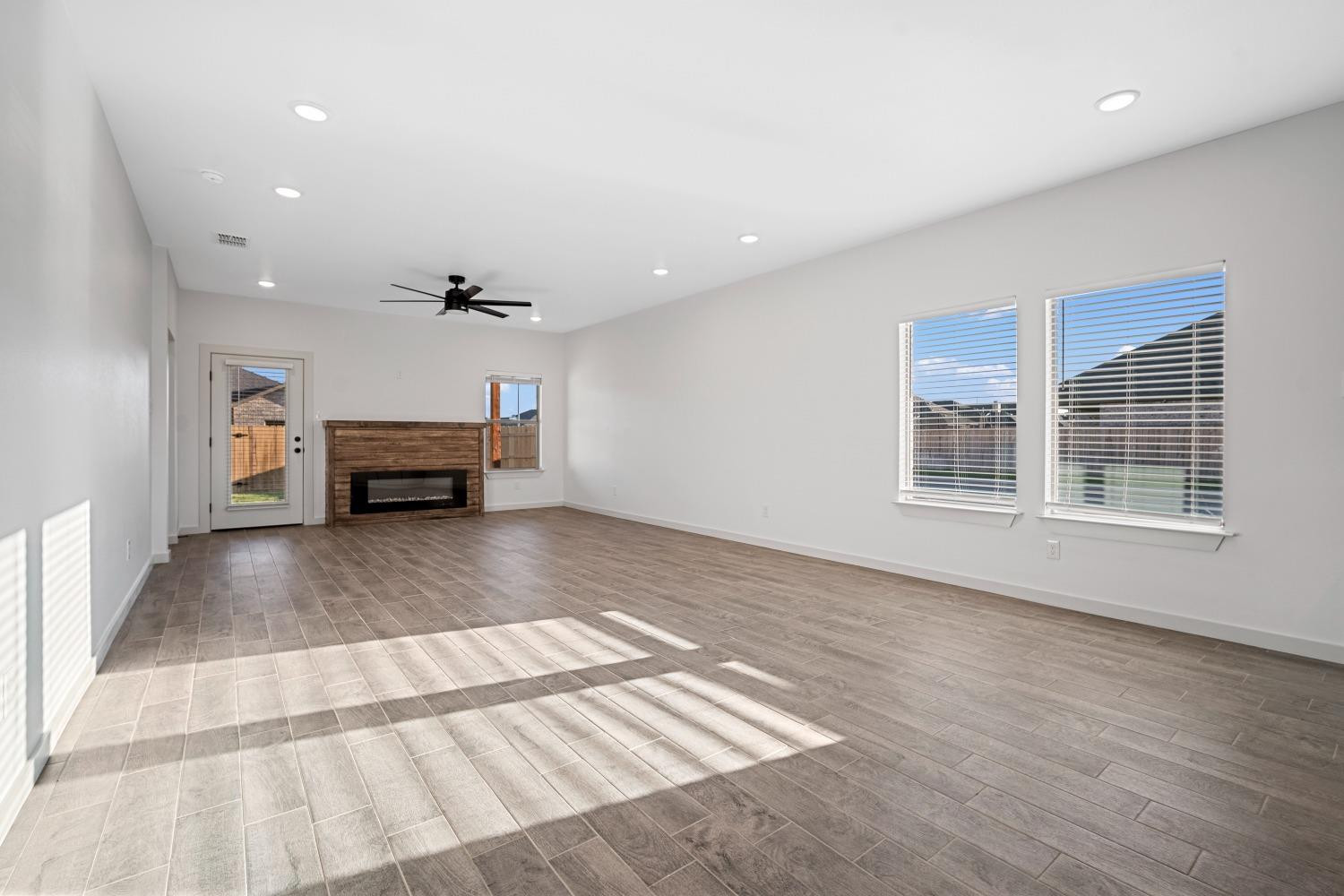 5902 Grinnell Street Lubbock, TX 79416 - Photo 5 of 26 a view of empty room with wooden floor and furniture