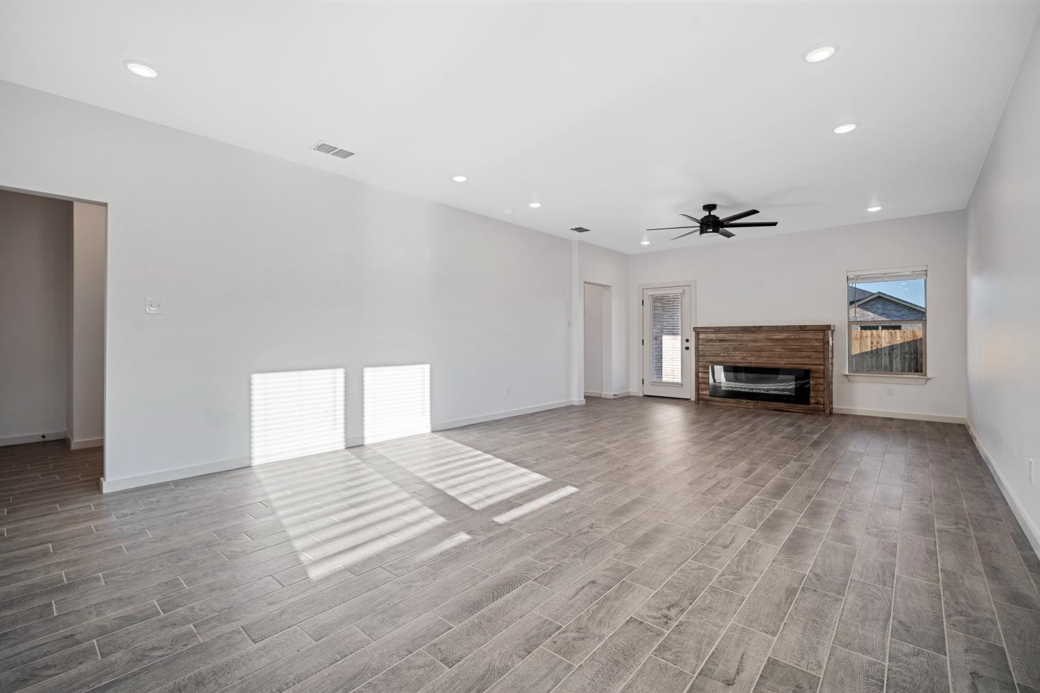 5902 Grinnell Street Lubbock, TX 79416 - Photo 6 of 26 a view of an empty room with fire place